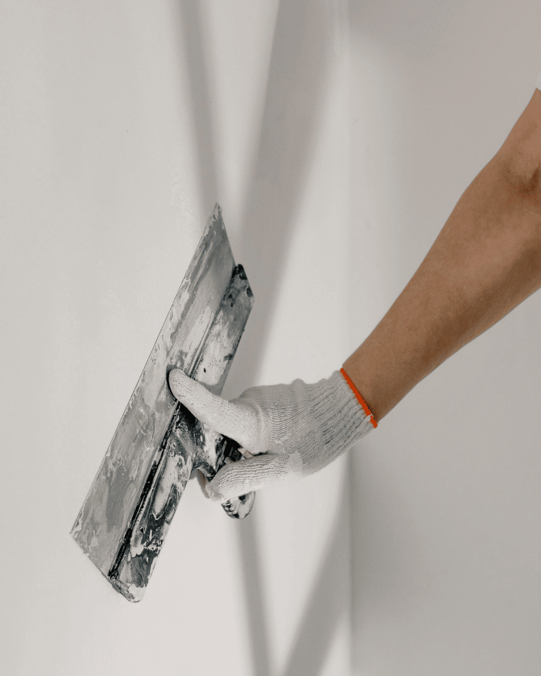 plasterer re-skimming wall in older London property
